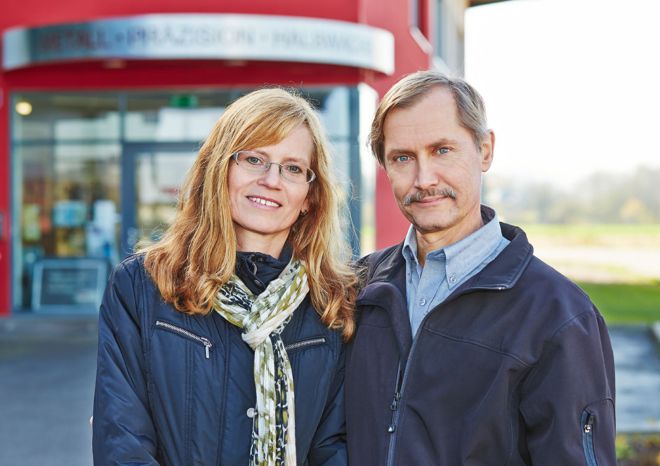 Margit und Manfred Halbwachs stehen vor dem Haupteingang des Unternehmens MPH.
